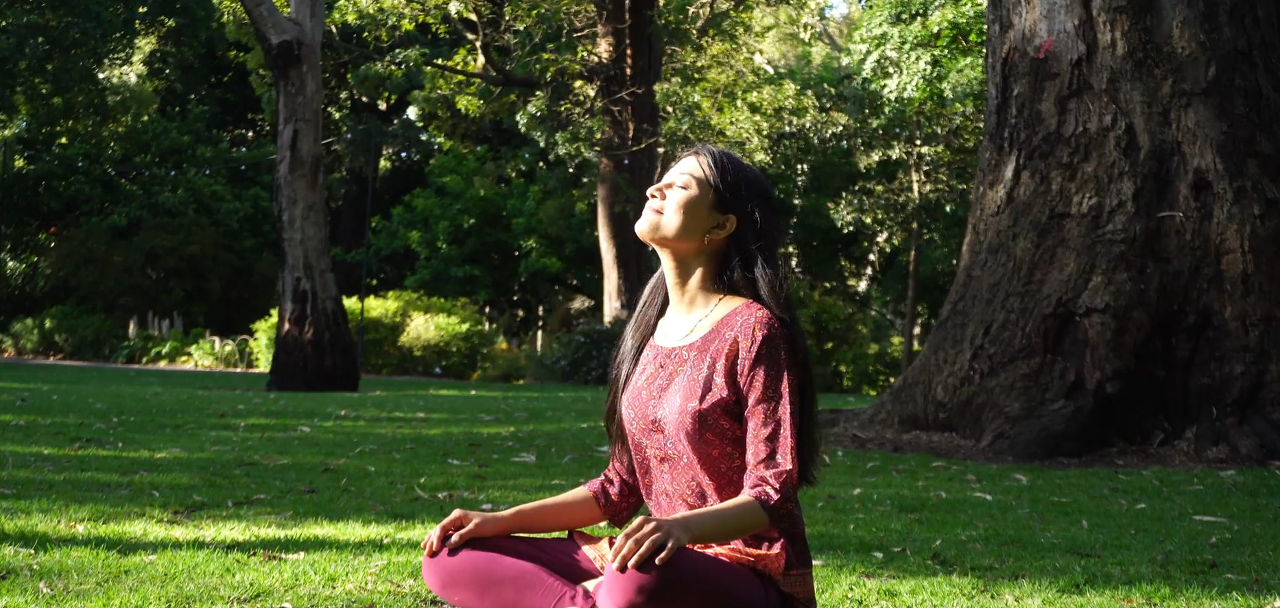 Woman practicing mindfulness in a sunlit park