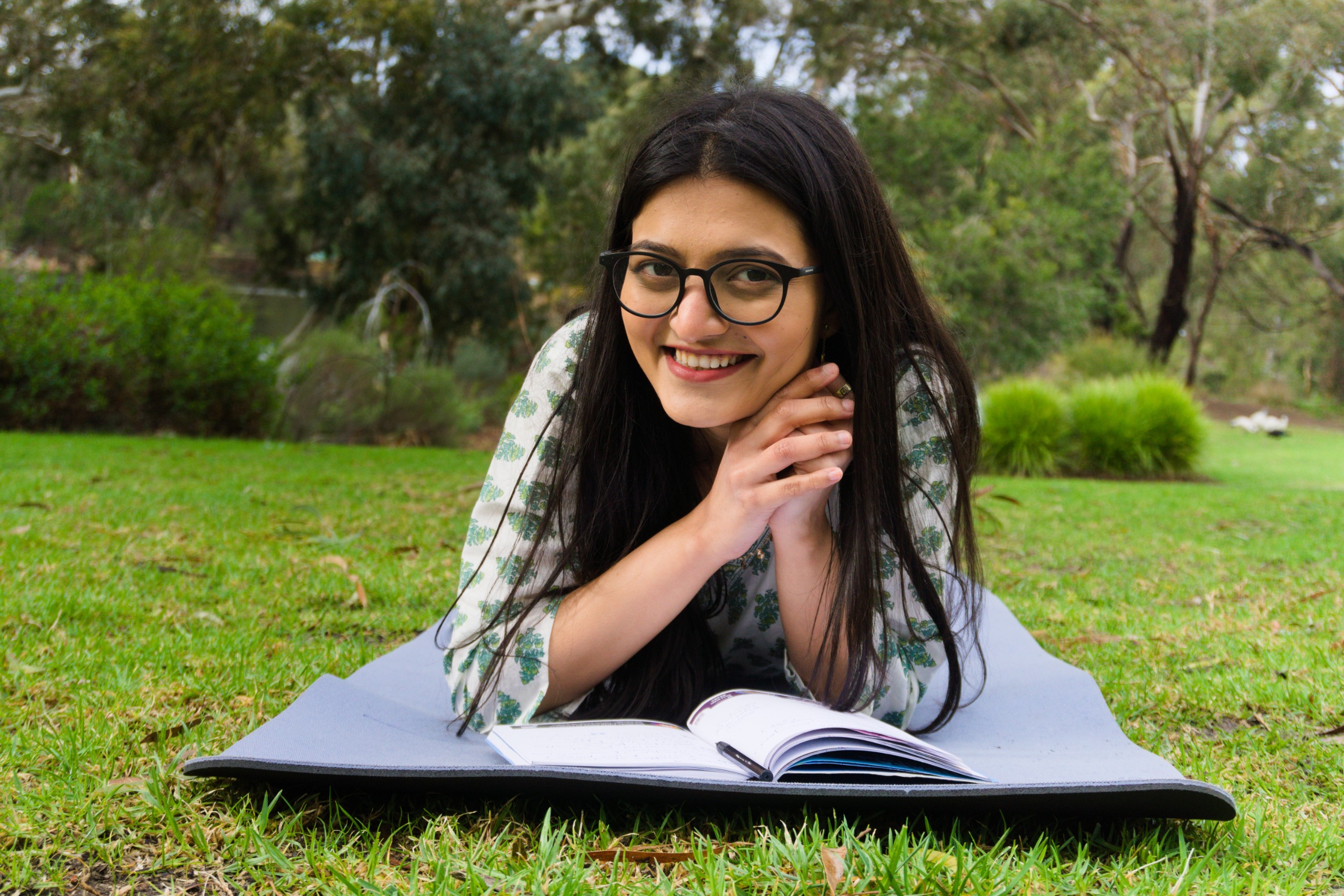 Woman reading outdoors in a peaceful garden setting